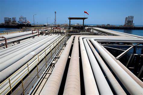 Oil tumbles, Taiwan's dollar surges at start of central bank-packed week